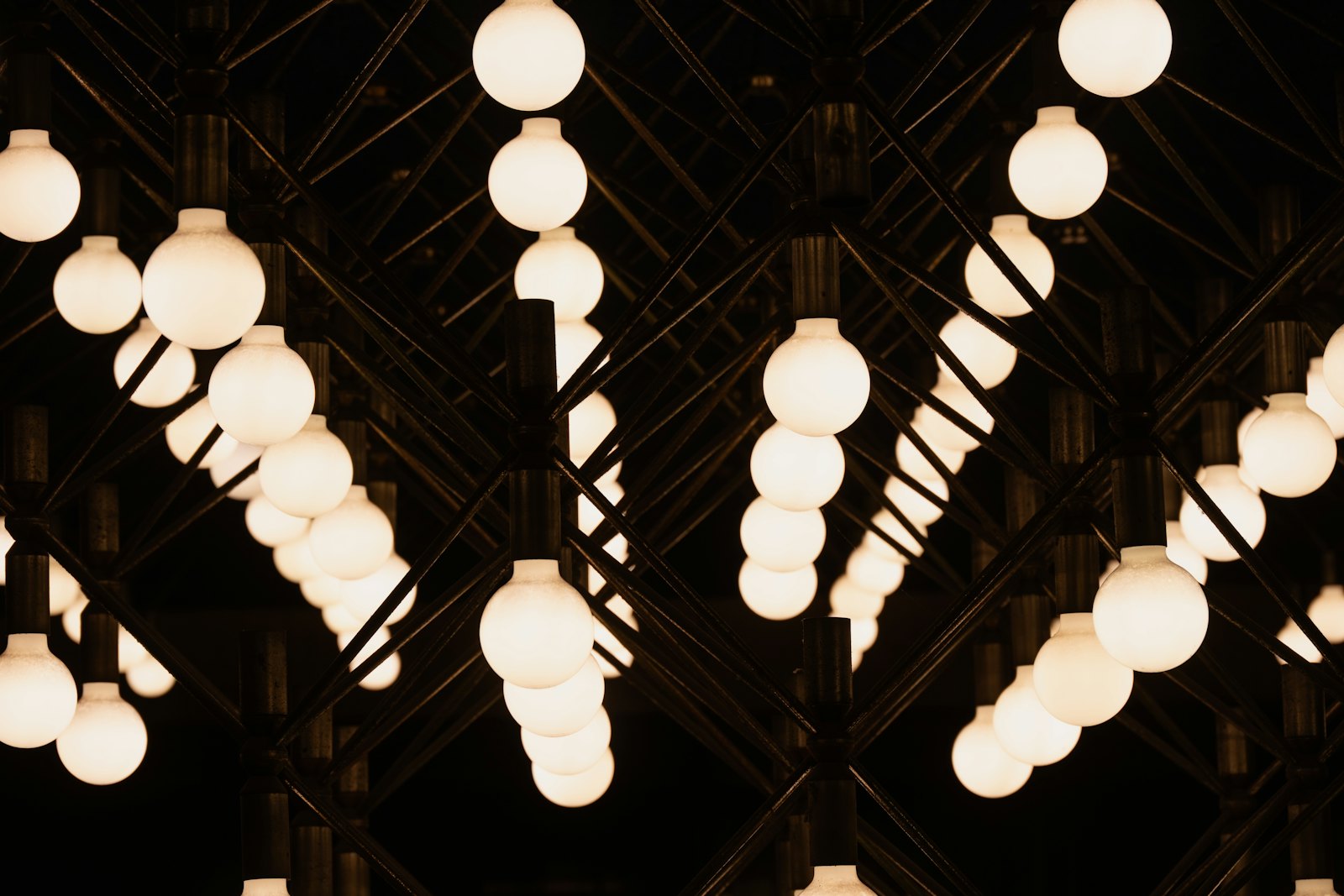 A row of illuminated light bulbs hanging from the ceiling