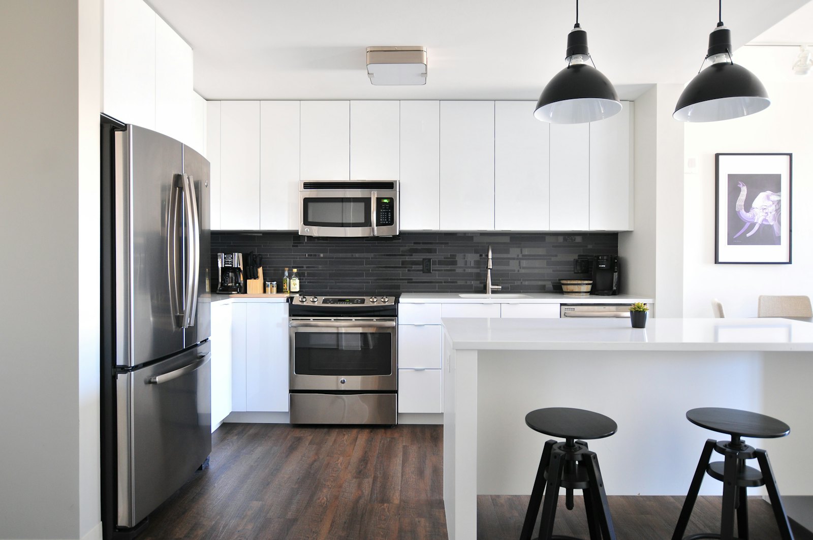 A modern kitchen with a stainless steel three-door refrigerator
